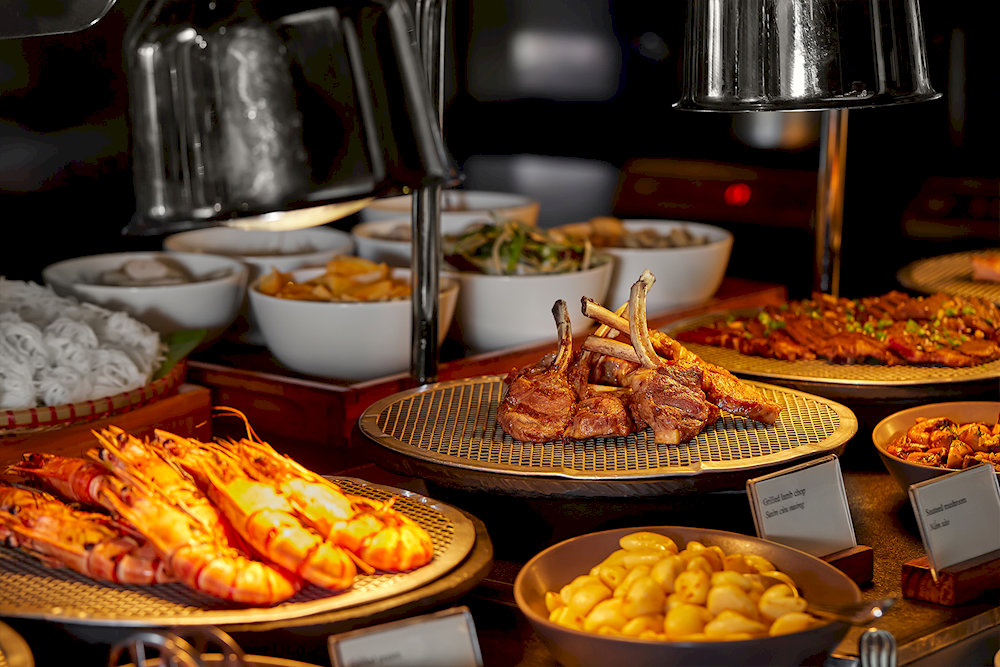 Premium buffet cuisine at Grill63 matches the spectacular elevation with culinary excellence