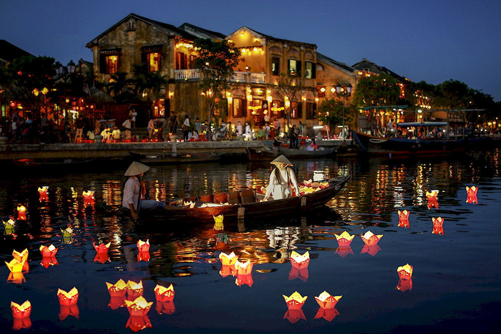 At night, Hoi An Ancient Town glows with colorful lanterns, creating a dreamy and enchanting atmosphere 