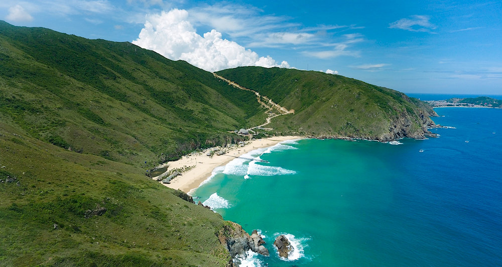 After arriving at Nhon Ly fishing village, you can take either a motorbike or a canoe to Ky Co Beach