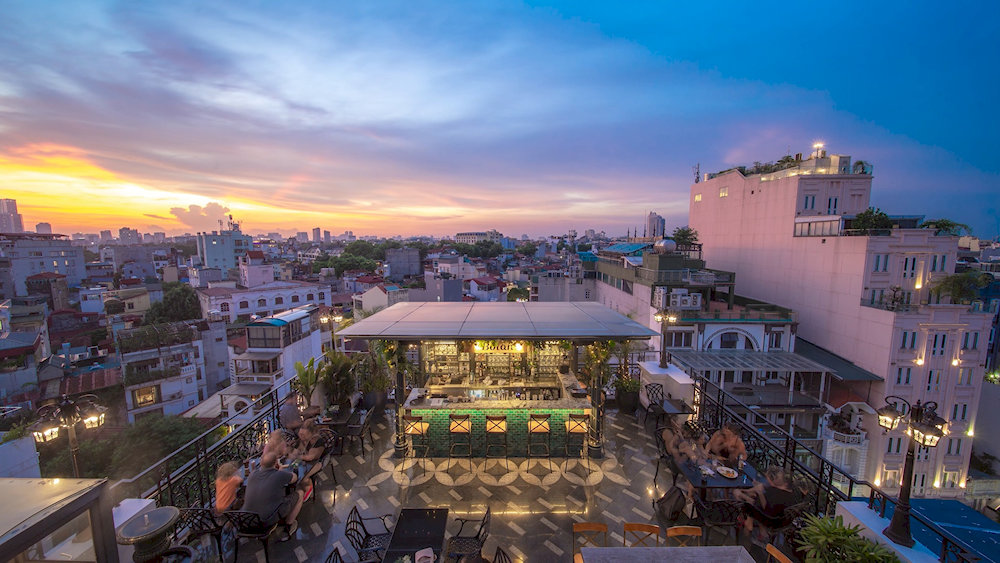 Botan Bar & Dine's rooftop bar setup creates a sophisticated atmosphere for cocktails and city viewing